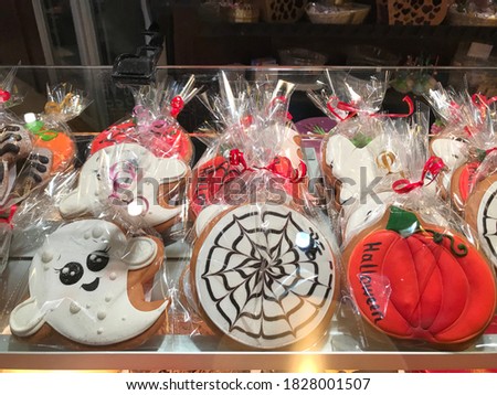 Variety of cookies decorated in style of Halloween in the pastry shop window.