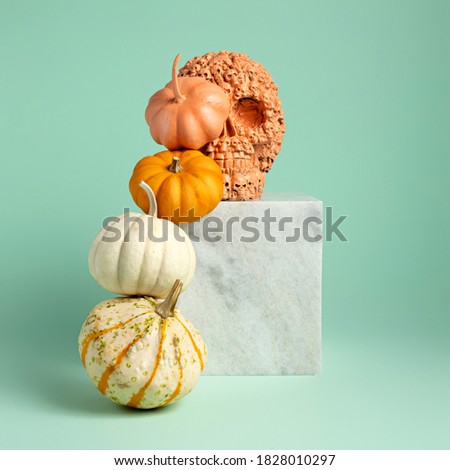 Creative Fall layout made of pumpkins and marble on mint background. Autumn, Halloween or Thanksgiving season concept. Scene stage showcase, for product, promotion, sale, banner, presentation.