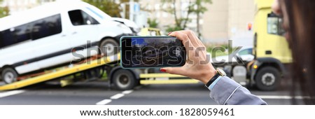 An insurance agent takes photo of crashed car after an accident on smartphone. Car insurance concept