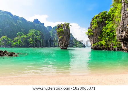 Famous James Bond island near Phuket in Thailand. Travel photo of James Bond island in Phang Nga bay, Thailand.  Royalty-Free Stock Photo #1828065371