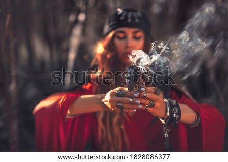 close up of woman hands with shamanic fire outdoors Royalty-Free Stock Photo #1828086377