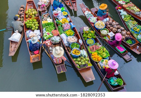 Top view Thailand traditional ancient floating market on the morning with some mist , they are on the local river for exchanging the agriculture food, fruit and vegetable. Royalty-Free Stock Photo #1828092353