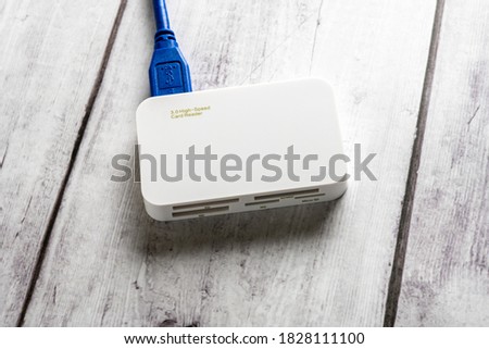 memory card reader on wooden white background