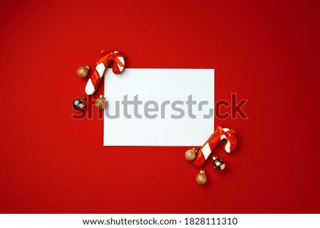 Blank sheet of paper with gingerbread cookies on red background