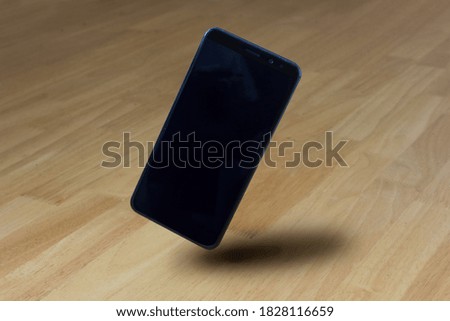 Blank screen realistic smartphone standing on wooden perspective floor, for advertising application presentation mockup.