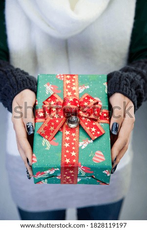 a close-up of a woman holding a gift box in her hands