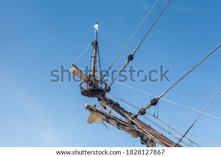 The top off ship mast and rigging on an old galleon navy vessel