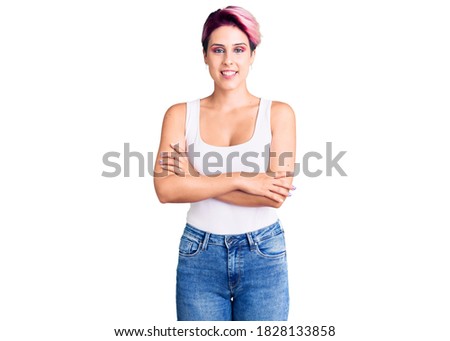 Young beautiful woman with pink hair wearing casual clothes happy face smiling with crossed arms looking at the camera. positive person. 