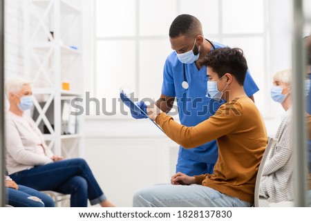 Coronavirus Medical Treatment. Asian Patient Signing Papers With Doctor Consent To Covid-19 Test Or Corona Virus Vaccination Sitting In Hospital. Covid Pandemic Concept. Copy Space