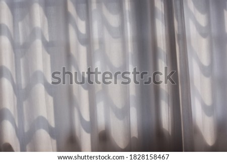 white curtain in front of window in sunny day