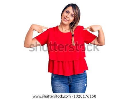 Young beautiful woman wearing casual t-shirt looking confident with smile on face, pointing oneself with fingers proud and happy. 