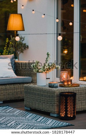 Cozy summer evening on the patio of beautiful suburban house with garden