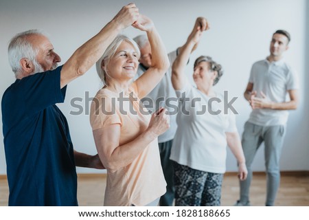 Older people dancing with their partners on a dancing course