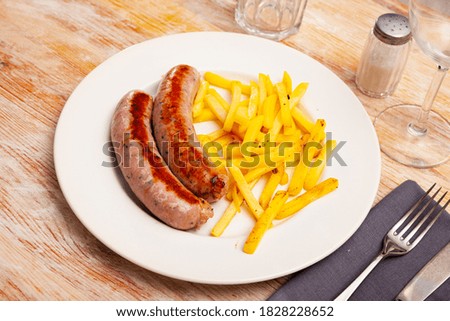 Image of tasty fried meat sausages served with french fries, nobody