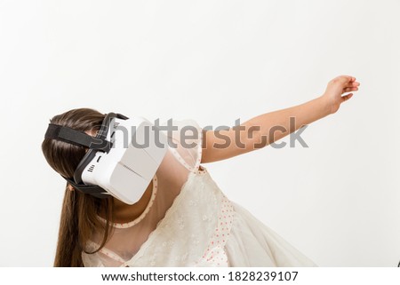 Young girl wearing virtual reality VR goggles