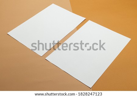 Blank poster brochure a4 size mockup template on half beige and brown background.