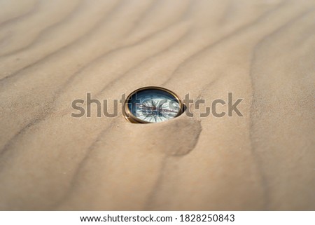 ancient compass on desert sand