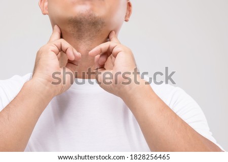 Lymphoma in men concept : Portrait Asian man is touching on his neck at lymph node position. Studio shot isolated on grey background Royalty-Free Stock Photo #1828256465