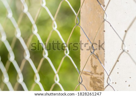 Braided wire fence on concrete pillars 