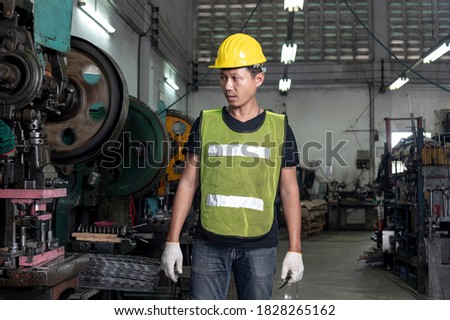 Engineer checking and inspects quality of industrail machine in factory with confident  Royalty-Free Stock Photo #1828265162