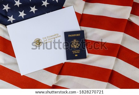 U.S. Citizenship and Immigration Services of naturalization with USA passport over U.S. flag