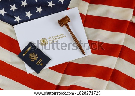 US Passports with wooden judge gavel on American flag on legal world immigration concepts a citizenship Royalty-Free Stock Photo #1828271729