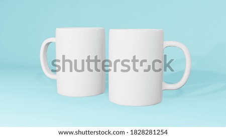Realistic two white cup isolated on light blue background, Template for Mock Up