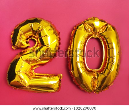 Number 20 twenty is made of a balloon, on a pink background. Balloon made of gold foil with helium. Party decoration, anniversary sign for holidays, celebration, Birthday, carnival