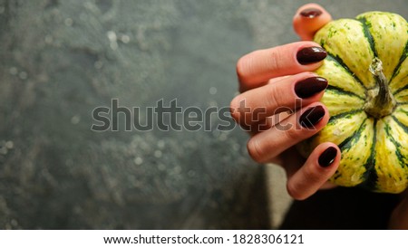nails with pumpkins and autumn leaves. trendy nails design. top view. place for text. flat lay pictures