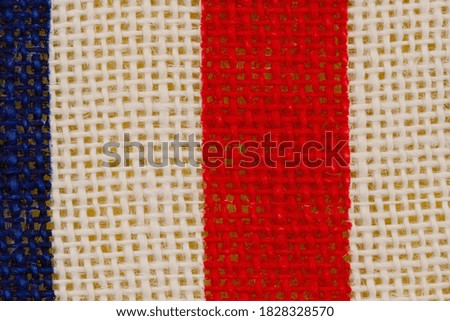 Red, white and blue grunge burlap textured weave material background with copy space for American message