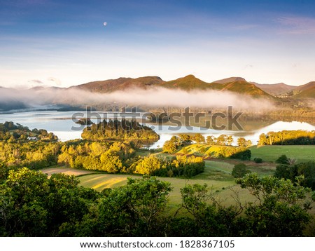 Derwentwater with Catbells in the background on a crisp morning as the sun is rising.