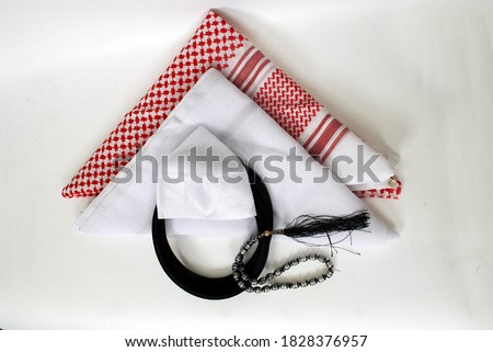 Arabic traditional clothing accessories Agal, Islamic cap and rosary,Shemagh with white Ghutrah isolated on white background Royalty-Free Stock Photo #1828376957