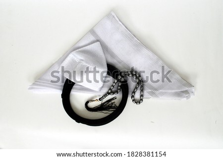 Arabic traditional clothing accessories Islamic cap and Rosary  Agal and white Ghutrah with white background Royalty-Free Stock Photo #1828381154