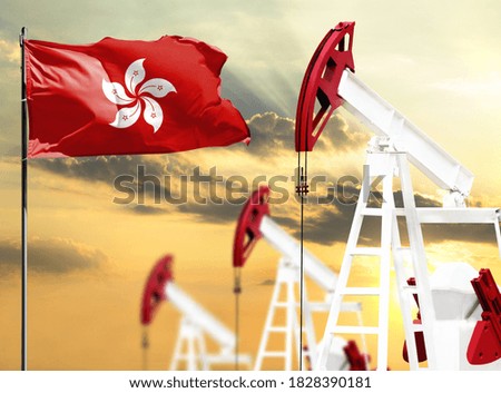 Oil rigs against the backdrop of the colorful sky and a flagpole with the flag of Hong Kong. The concept of oil production, minerals, development of new deposits.