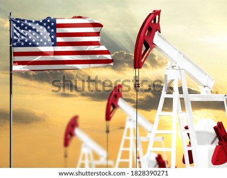 Oil rigs against the backdrop of the colorful sky and a flagpole with the flag of America. The concept of oil production, minerals, development of new deposits.