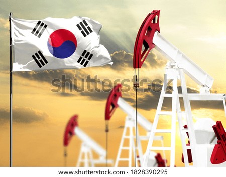 Oil rigs against the backdrop of the colorful sky and a flagpole with the flag of South Korea. The concept of oil production, minerals, development of new deposits.