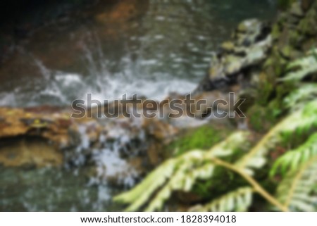 Blurry splashing water in a natural pool  for background                 