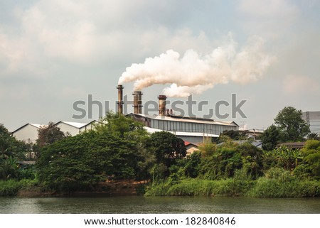 Chimney and white smoke in factory area