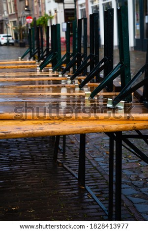 Wooden tables after the heavy rain in Leiden, Netherlands 
