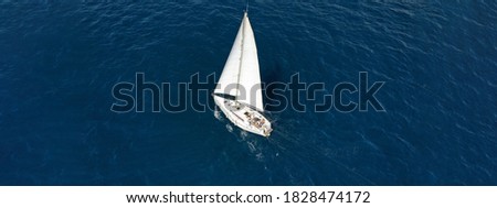 Aerial drone ultra wide photo of sail boat cruising deep blue Ionian sea