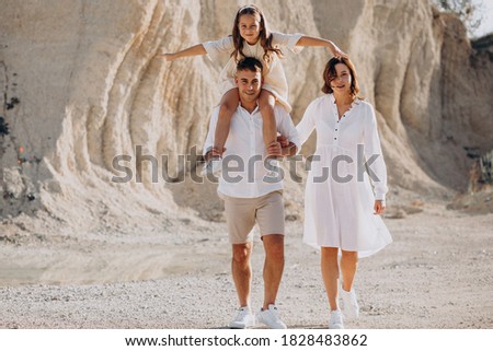 Young family with daughter walking out together
