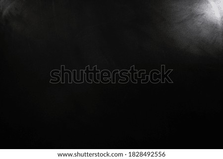 Chalkboard texture background with spotlight. blackboard wall backdrop wallpaper, dark tone. black banner billboard.
