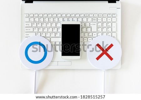 Laptops, smartphones and true or false sign shot on a white background
