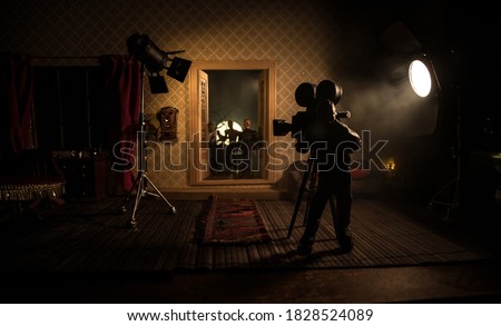 A realistic dollhouse living room with furniture, door and window at night. Horror movie backstage concept. Selective focus.