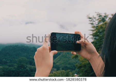 A woman take a picture by smartphone 