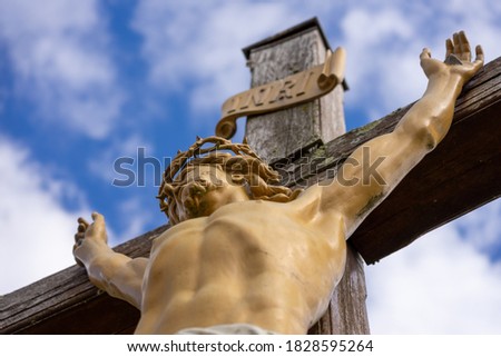 Christ on the cross with blue sky in summer