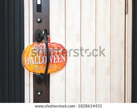 Hanging Happy Halloween sign on the door.