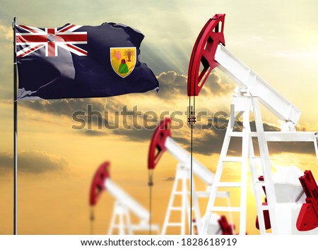 Oil rigs against the backdrop of the colorful sky and a flagpole with the flag of Turks and Caicos Islands. The concept of oil production, minerals, development of new deposits.