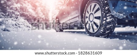 The car stopped on the roadside under the bright cold sun. Vehicle is covering with snow. There is a snowfall. Royalty-Free Stock Photo #1828631609