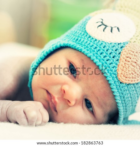 newborn baby in a bright knitted hat